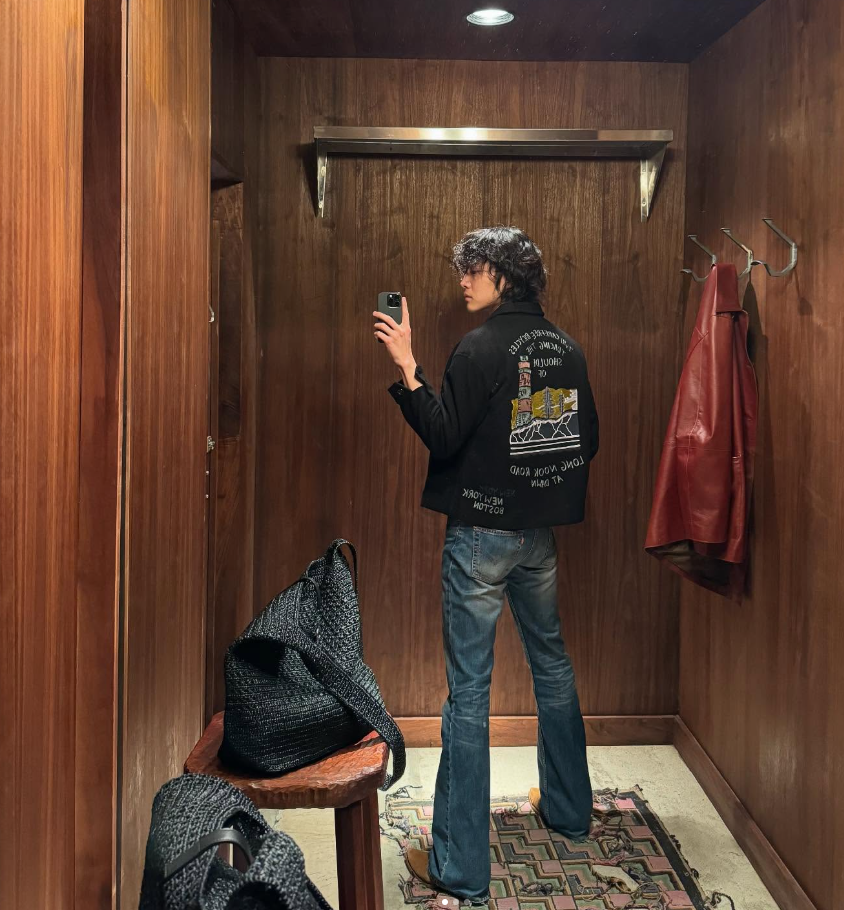 Mirror selfie Leon dengan jaket hitam dan jeans